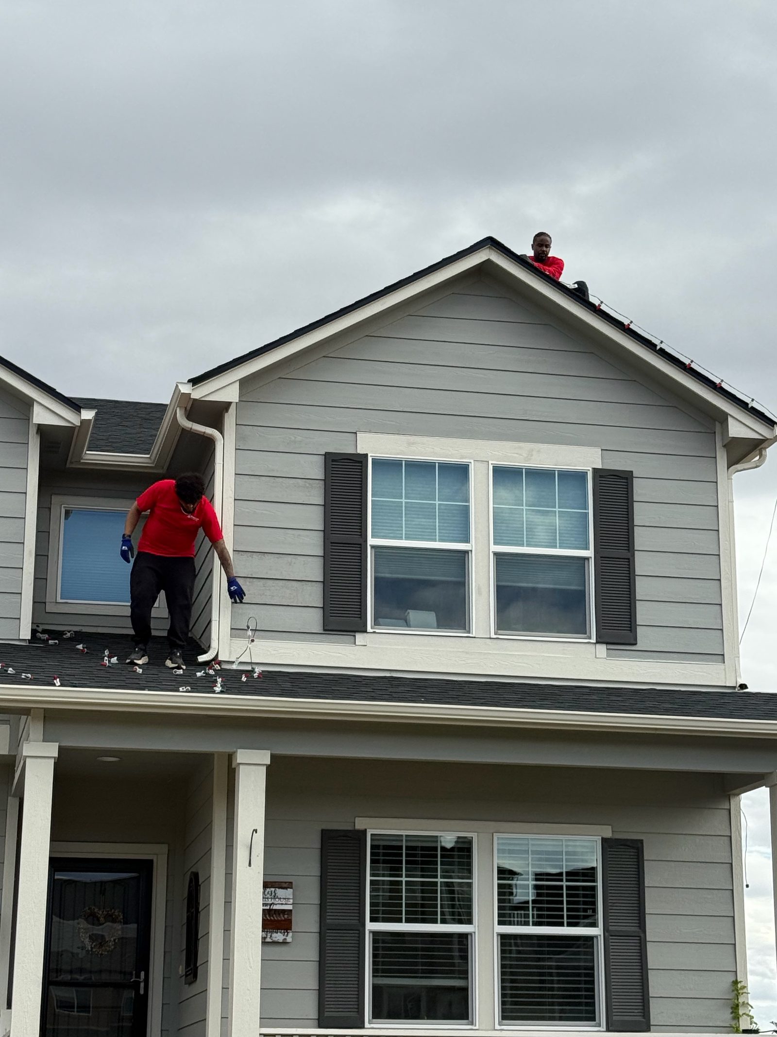 Professional Christmas light installation crew on roof installing LED lights, Front Range portfolio