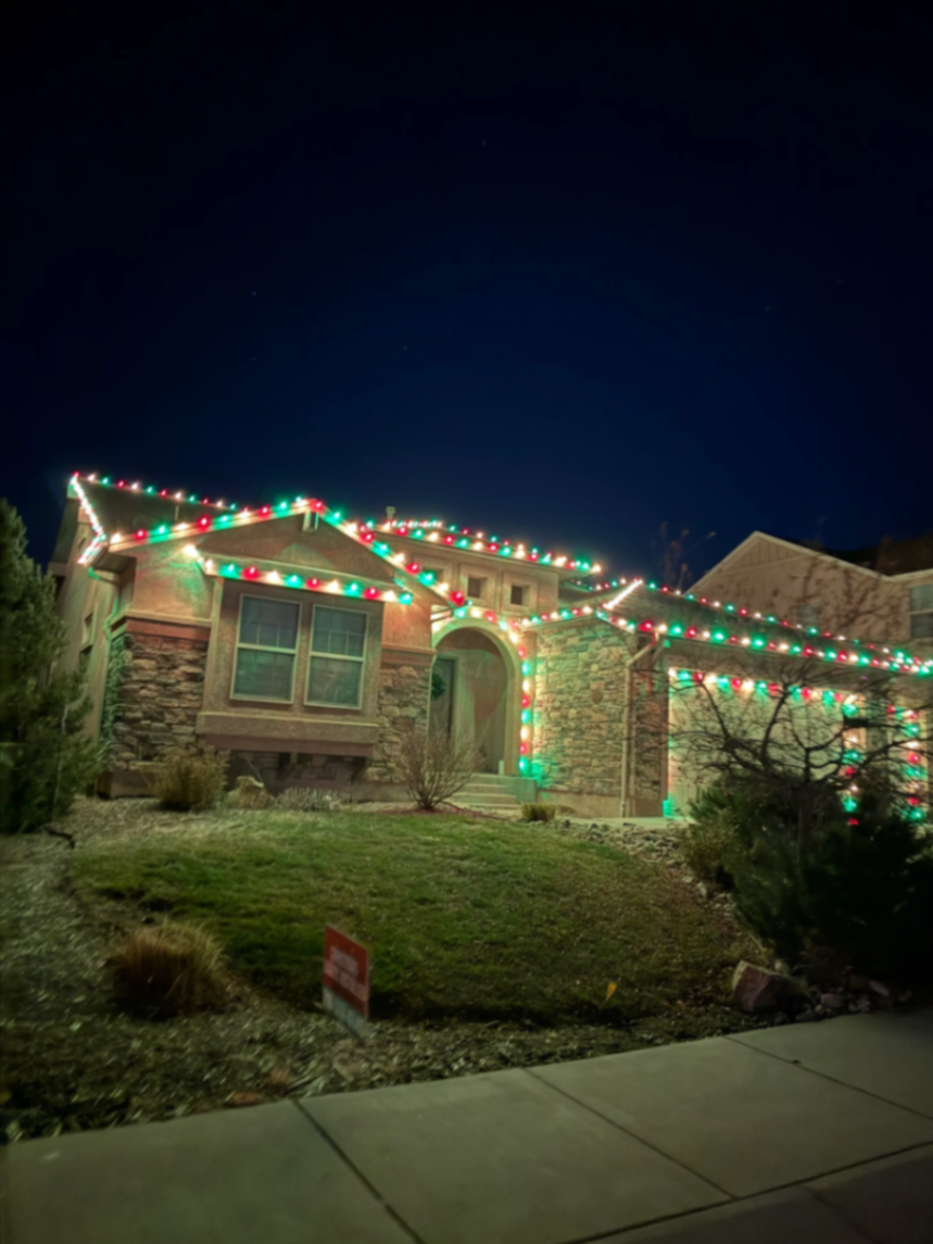 Front Range portfolio: multicolor Christmas lights on a two-story home with landscape lighting