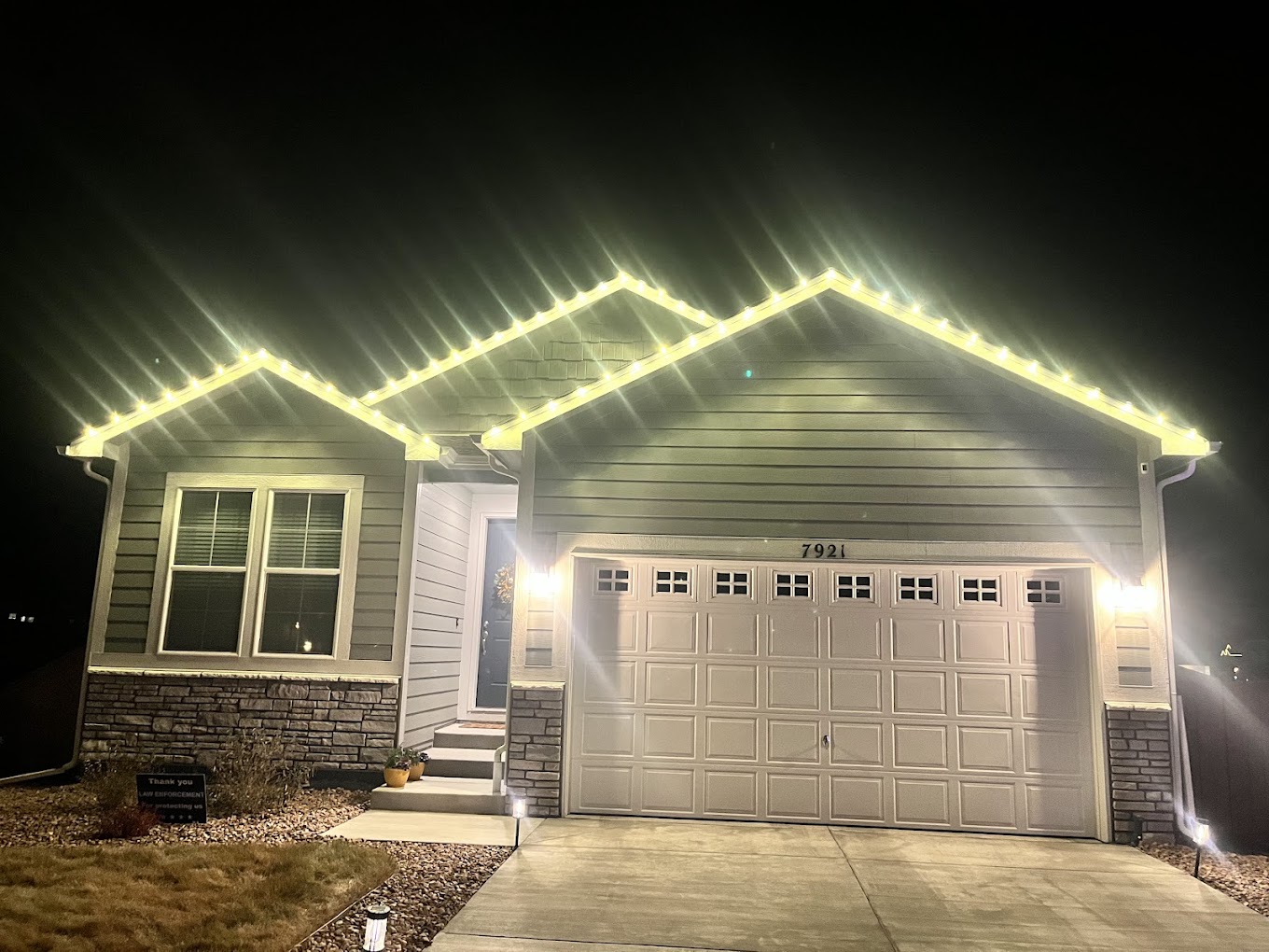 Warm white roofline Christmas light installation on a Front Range home